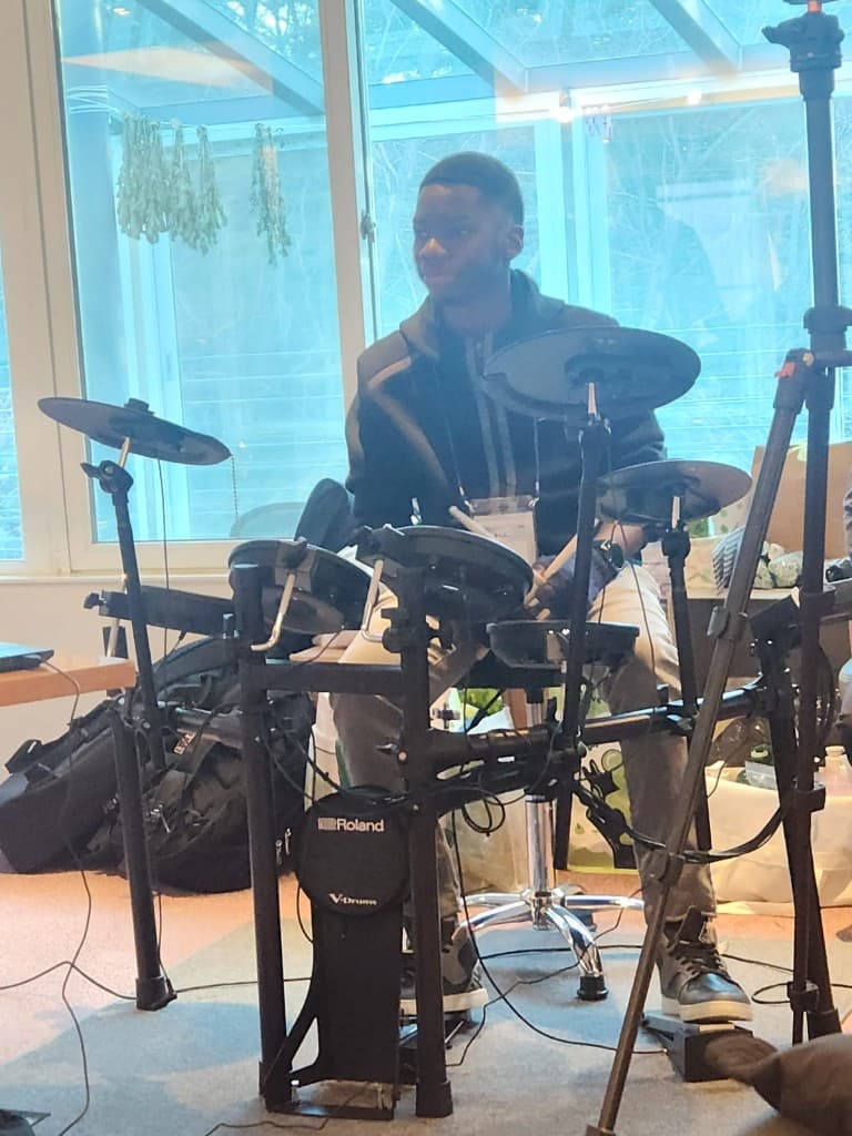 Francis playing Roland V-Drums at a gathering